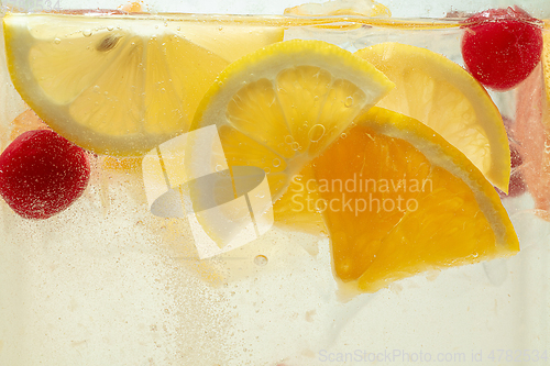 Image of Close up view of the lemon slices in lemonade on background