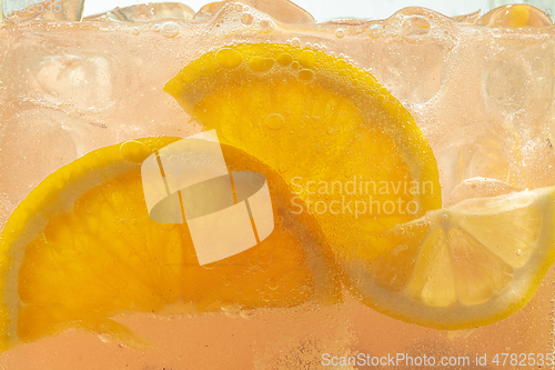 Image of Close up view of the lemon slices in lemonade on background