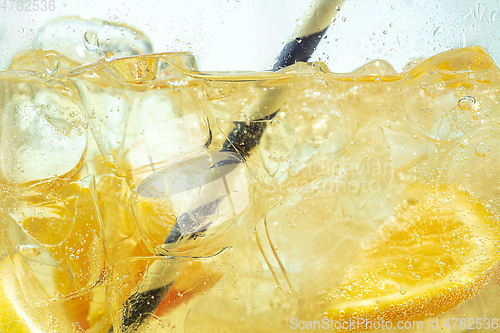 Image of Close up view of the lemon slices in lemonade on background