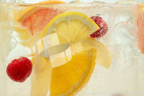 Image of Close up view of the lemon slices in lemonade on background