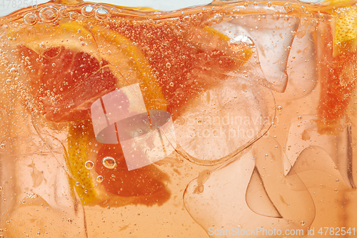 Image of Close up view of the lemon and grapefruit slices in lemonade on background