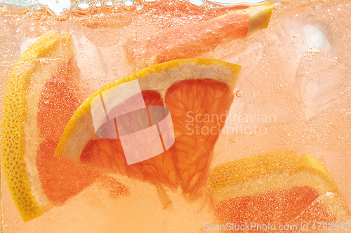 Image of Close up view of the lemon and grapefruit slices in lemonade on background