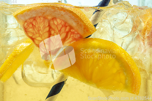 Image of Close up view of the lemon slices in lemonade on background