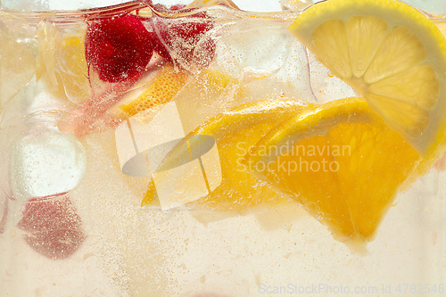 Image of Close up view of the lemon slices in lemonade on background