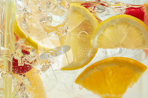 Image of Close up view of the lemon slices in lemonade on background