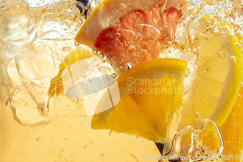 Image of Close up view of the lemon slices in lemonade on background