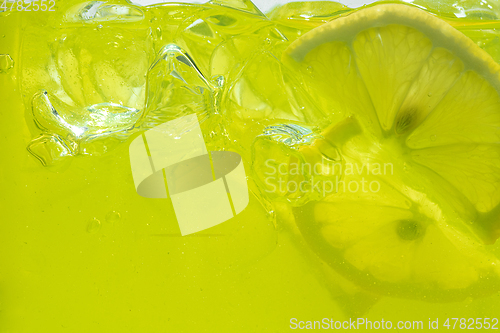 Image of Close up view of the lemon slices in lemonade on background