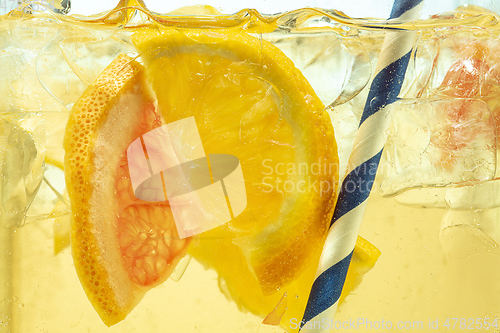 Image of Close up view of the lemon slices in lemonade on background