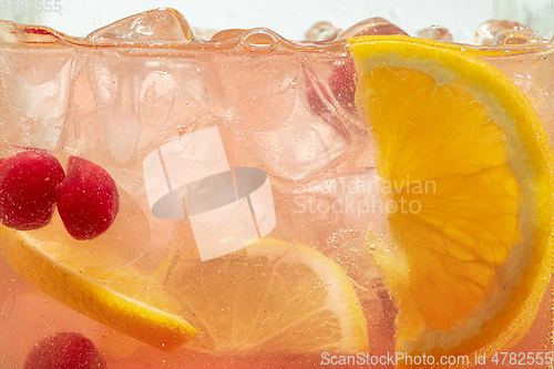 Image of Close up view of the lemon slices in lemonade on background