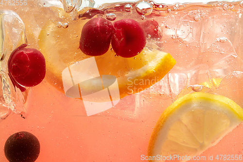 Image of Close up view of the lemon slices in lemonade on background