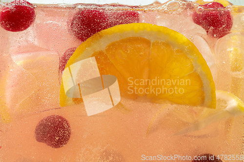 Image of Close up view of the lemon slices in lemonade on background