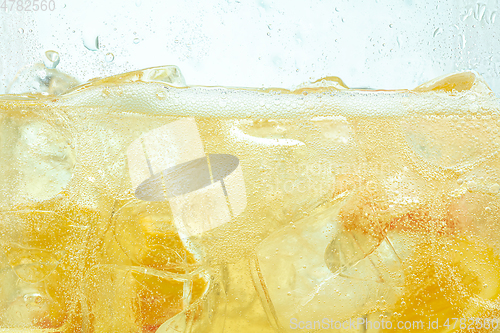 Image of Close up view of the lemon slices in lemonade on background