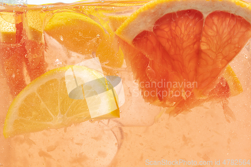 Image of Close up view of the lemon and grapefruit slices in lemonade on background