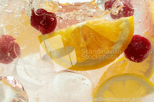 Image of Close up view of the lemon slices in lemonade on background