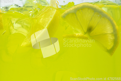 Image of Close up view of the lemon slices in lemonade on background