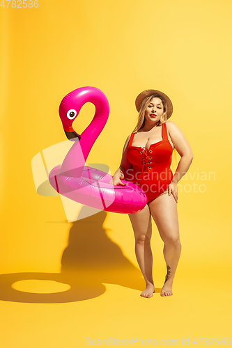 Image of Young caucasian plus size female model\'s preparing for beach resort