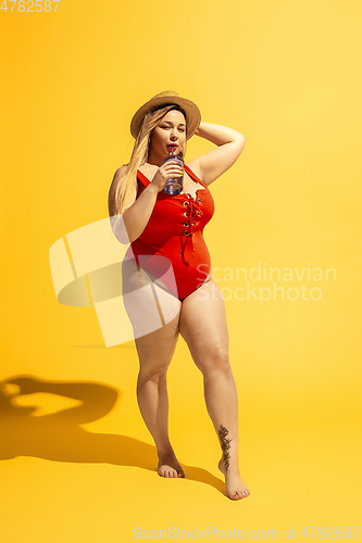 Image of Young caucasian plus size female model\'s preparing for beach resort