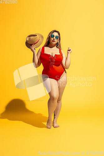 Image of Young caucasian plus size female model\'s preparing for beach resort