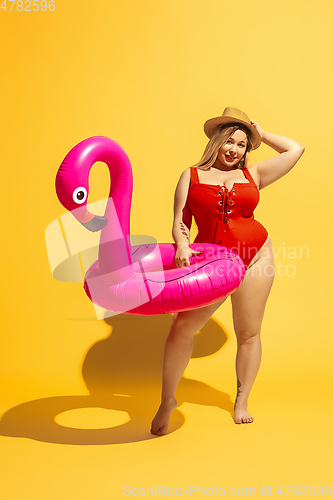 Image of Young caucasian plus size female model\'s preparing for beach resort