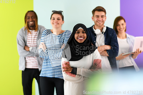 Image of group of diverse teenagers posing in a studio, determined teenagers in diverse clothing.