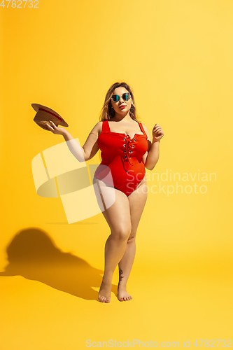 Image of Young caucasian plus size female model\'s preparing for beach resort