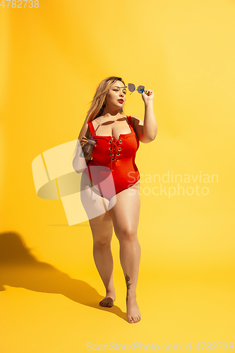 Image of Young caucasian plus size female model\'s preparing for beach resort