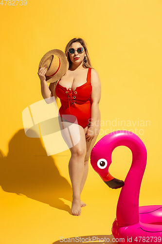 Image of Young caucasian plus size female model\'s preparing for beach resort