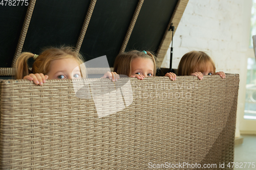 Image of Little girls in soft warm pajamas playing at home