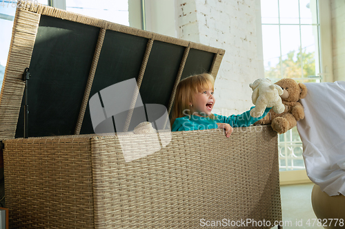 Image of Little girls in soft warm pajamas playing at home