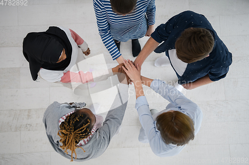 Image of top view of diverse group of people standing embracing and symbolizing togetherness