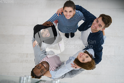 Image of top view of diverse group of people standing embracing and symbolizing togetherness