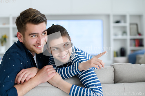 Image of a young married couple enjoys sitting in the large living room