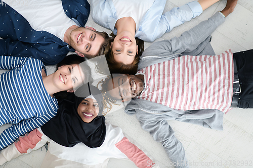 Image of top view of a diverse group of people lying on the floor and symbolizing togetherness