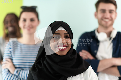 Image of group of diverse teenagers posing in a studio, determined teenagers in diverse clothing.