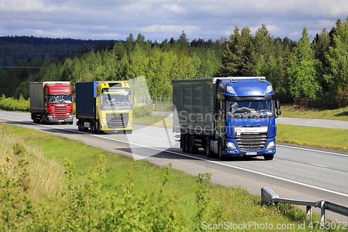 Image of Colorful Semi Trailer Trucks on Motorway