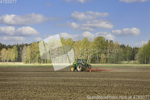 Image of John Deere Tractor and Harrow Working