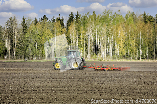 Image of John Deere Tractor and Harrow in Field