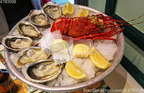 Image of Large dish of fresh seafood, oysters with lobster with lemon and