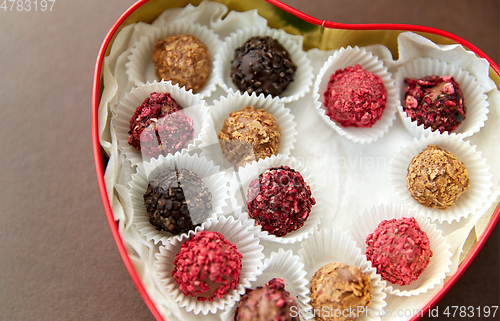 Image of candies in red heart shaped chocolate box