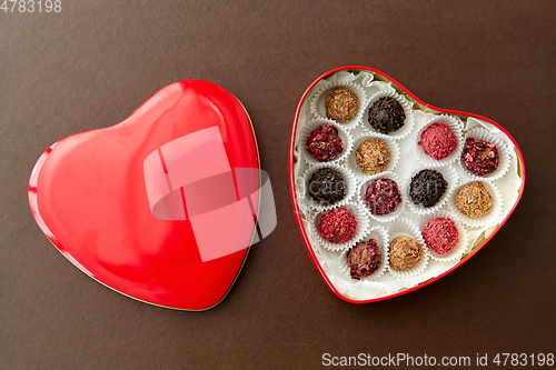 Image of candies in red heart shaped chocolate box
