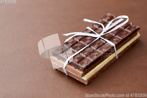 Image of different kinds of chocolate on brown background