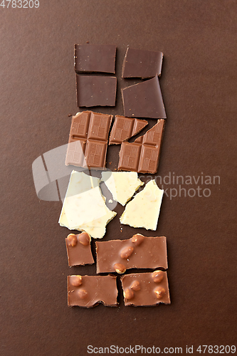 Image of different kinds of chocolate on brown background