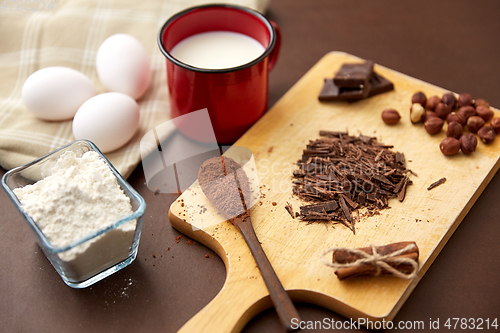 Image of chocolate, cocoa powder, milk, eggs and flour