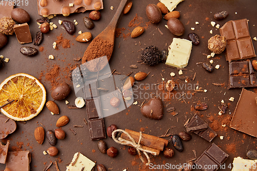 Image of cocoa beans, chocolate, nuts and cinnamon sticks