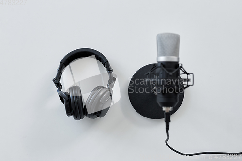 Image of headphones and microphone on white background