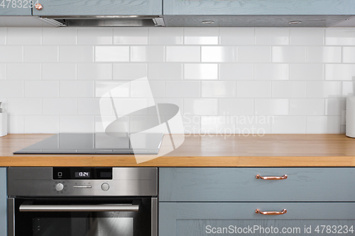 Image of modern home kitchen interior with oven and hob