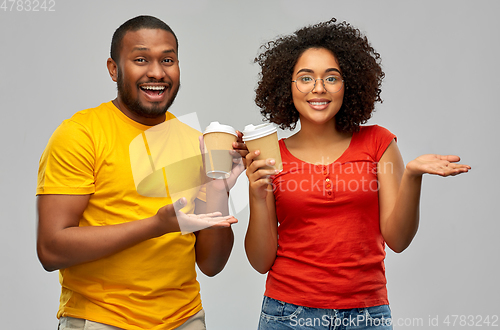 Image of happy african american couple with coffee cups