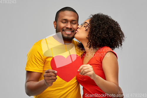 Image of happy african american couple wit red heart kiss