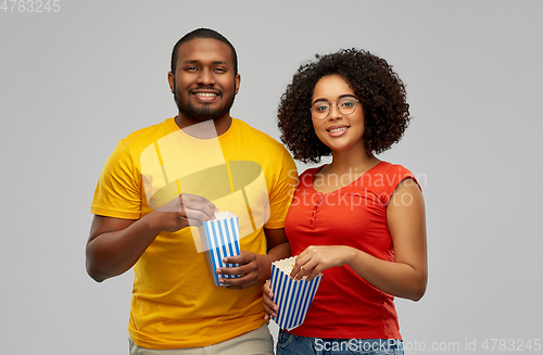 Image of happy african american couple eating popcorn