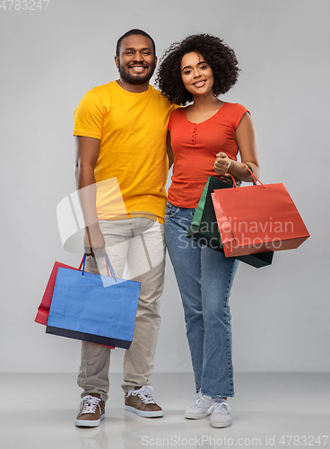 Image of happy african american couple with shopping bags